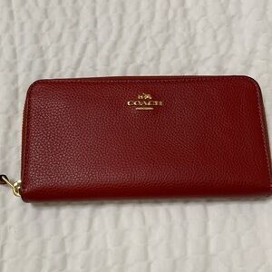 Coach red pebble leather long wallet.